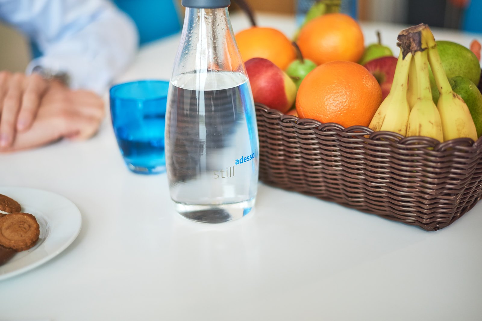 adesso water bottle and fruit basket on a table